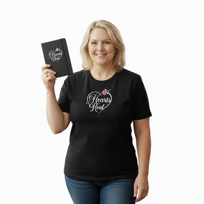 Woman wearing a black t-shirt with 'Hearts Heat' design, holding a matching notebook.