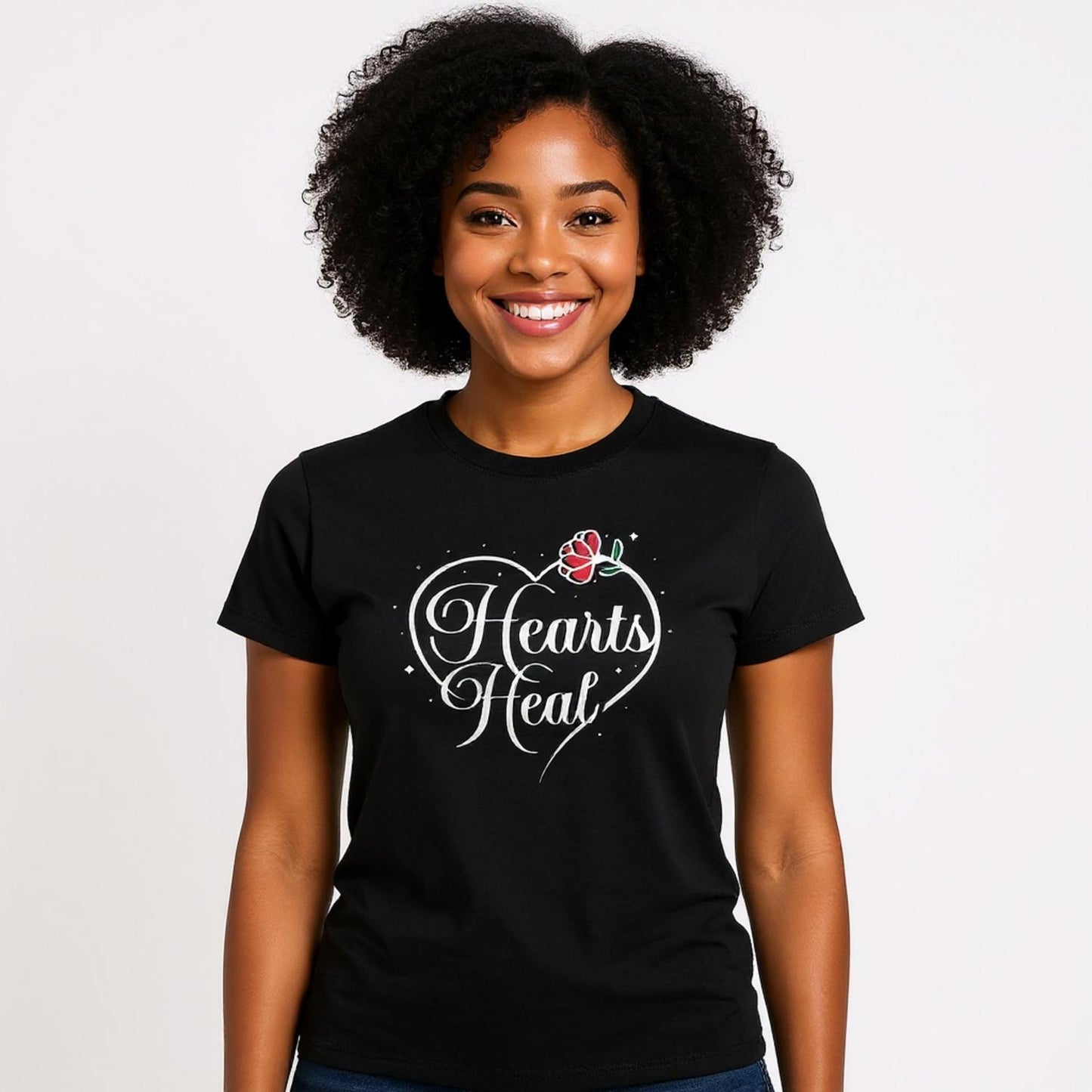 Woman wearing a black Hearts Heal heart t-shirt.