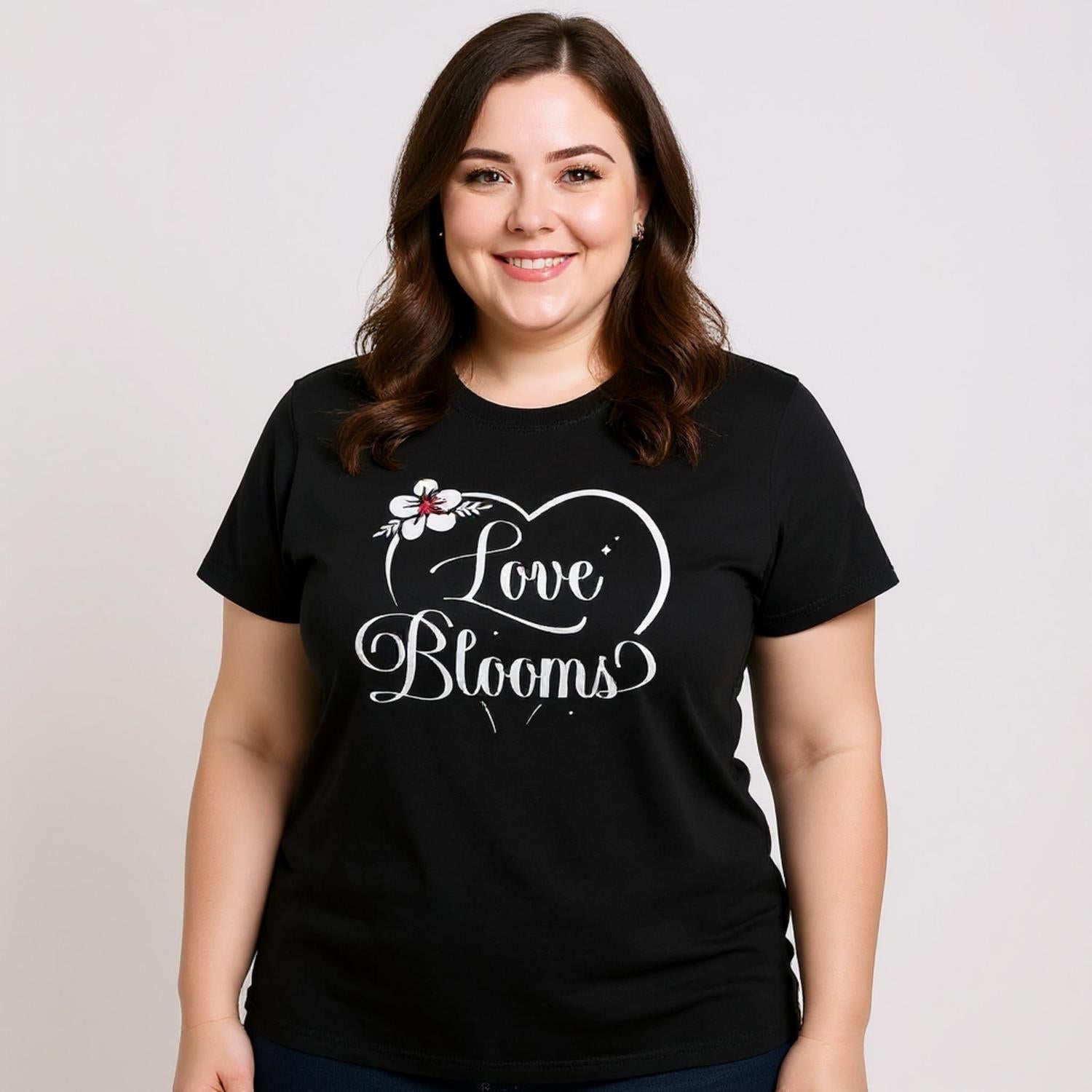 Woman wearing a black t-shirt with Love Blooms heart design.