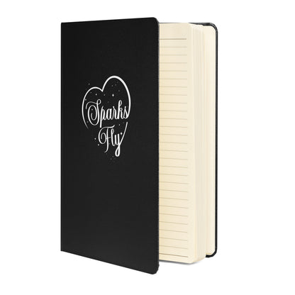 Black hardcover Sparks Fly Heart notebook with lined, cream-colored pages.