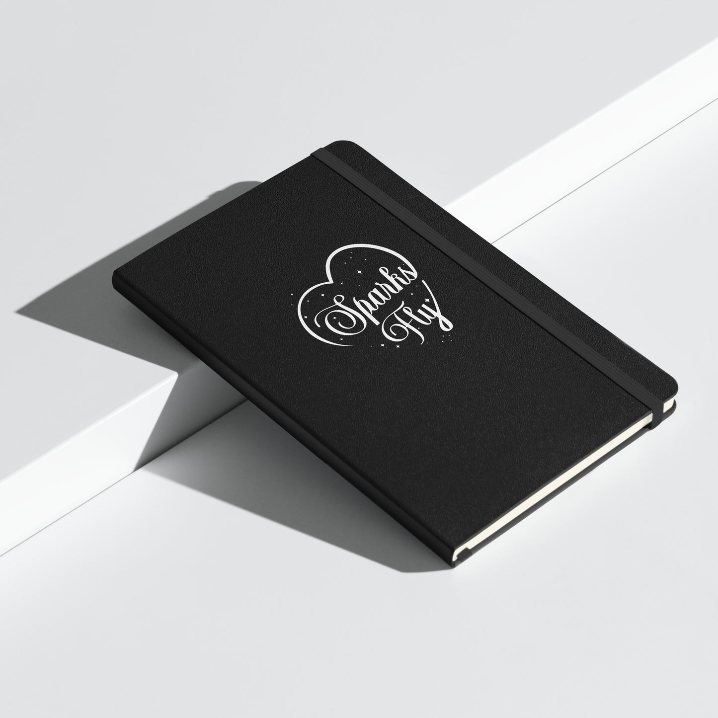 Black hardcover Sparks Fly Heart notebook.