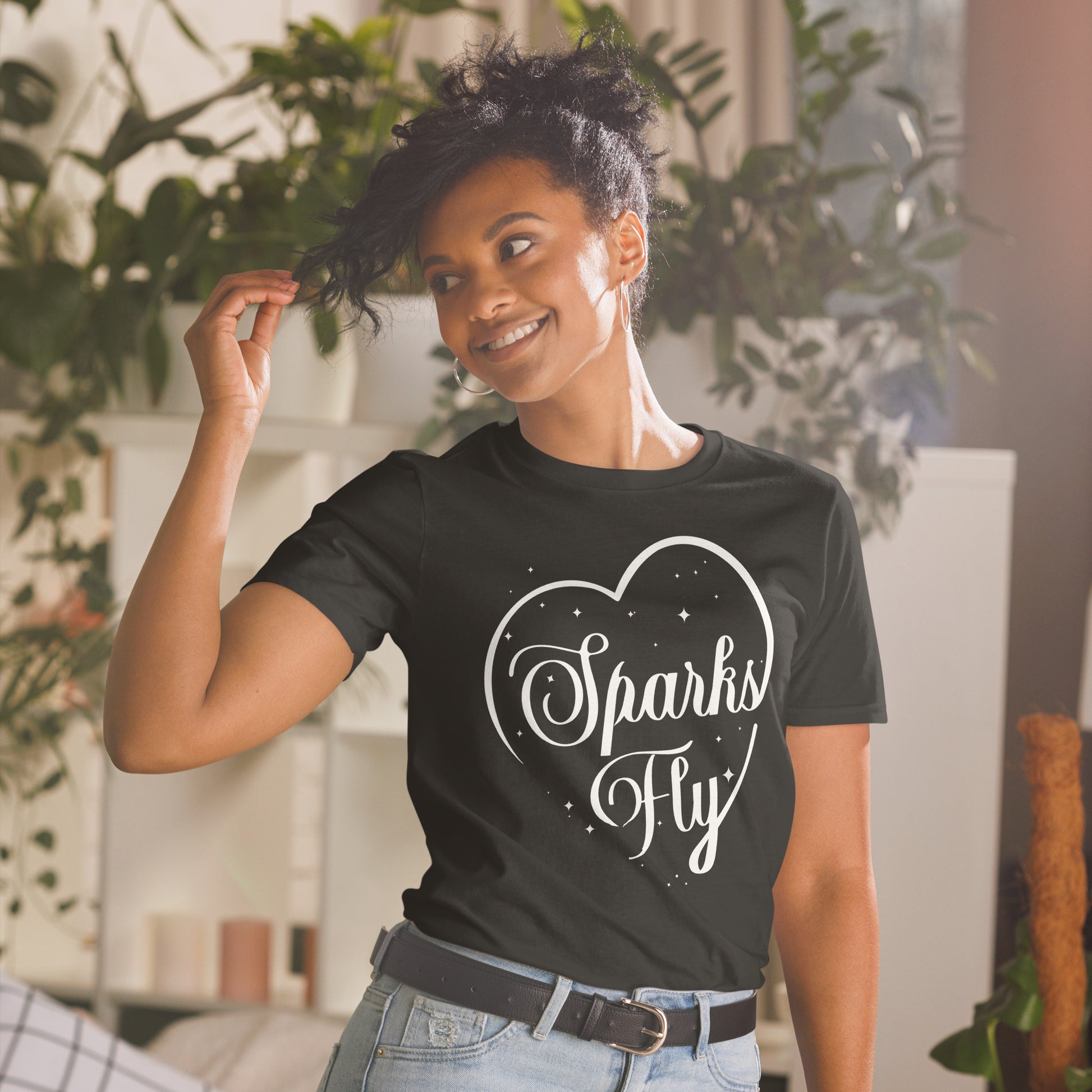 Woman wearing black Sparks Fly Hearts t-shirt.