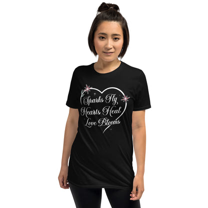 Woman wearing black Love's Journey Heart t-shirt. Heart with the words Sparks Fly, Hearts Heal, Love Blooms.