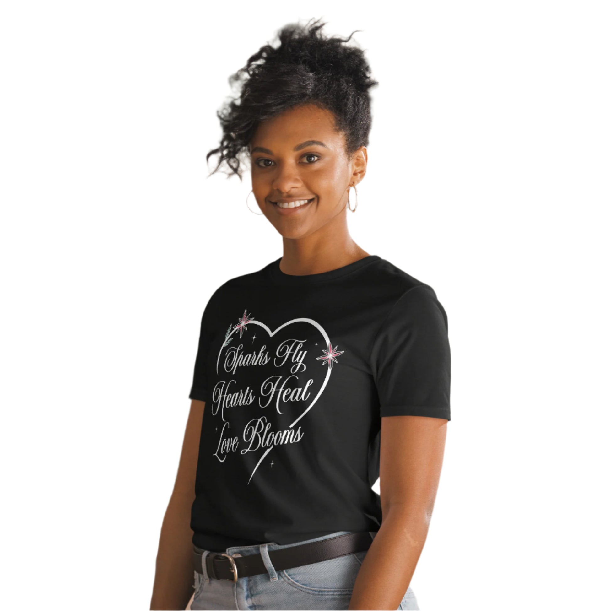 Woman wearing black Love's Journey Heart t-shirt. Heart with the words Sparks Fly, Hearts Heal, Love Blooms.