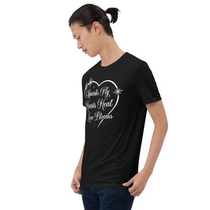 Woman wearing black Love's Journey Heart t-shirt. Heart with the words Sparks Fly, Hearts Heal, Love Blooms.